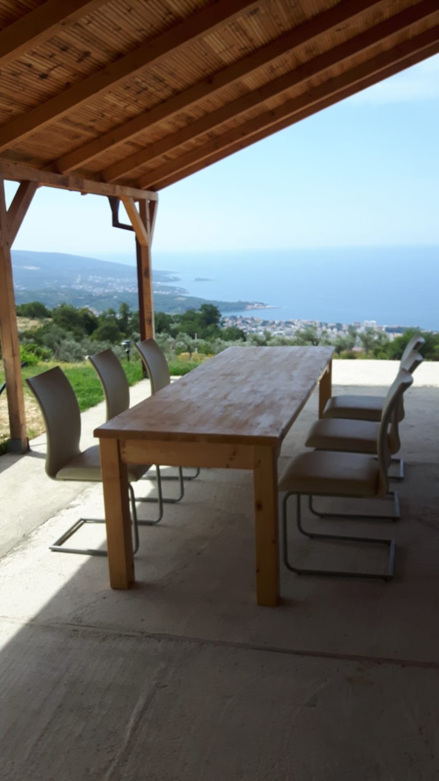 Wooden terrace at Olive Panorama Villa with outdoor dining